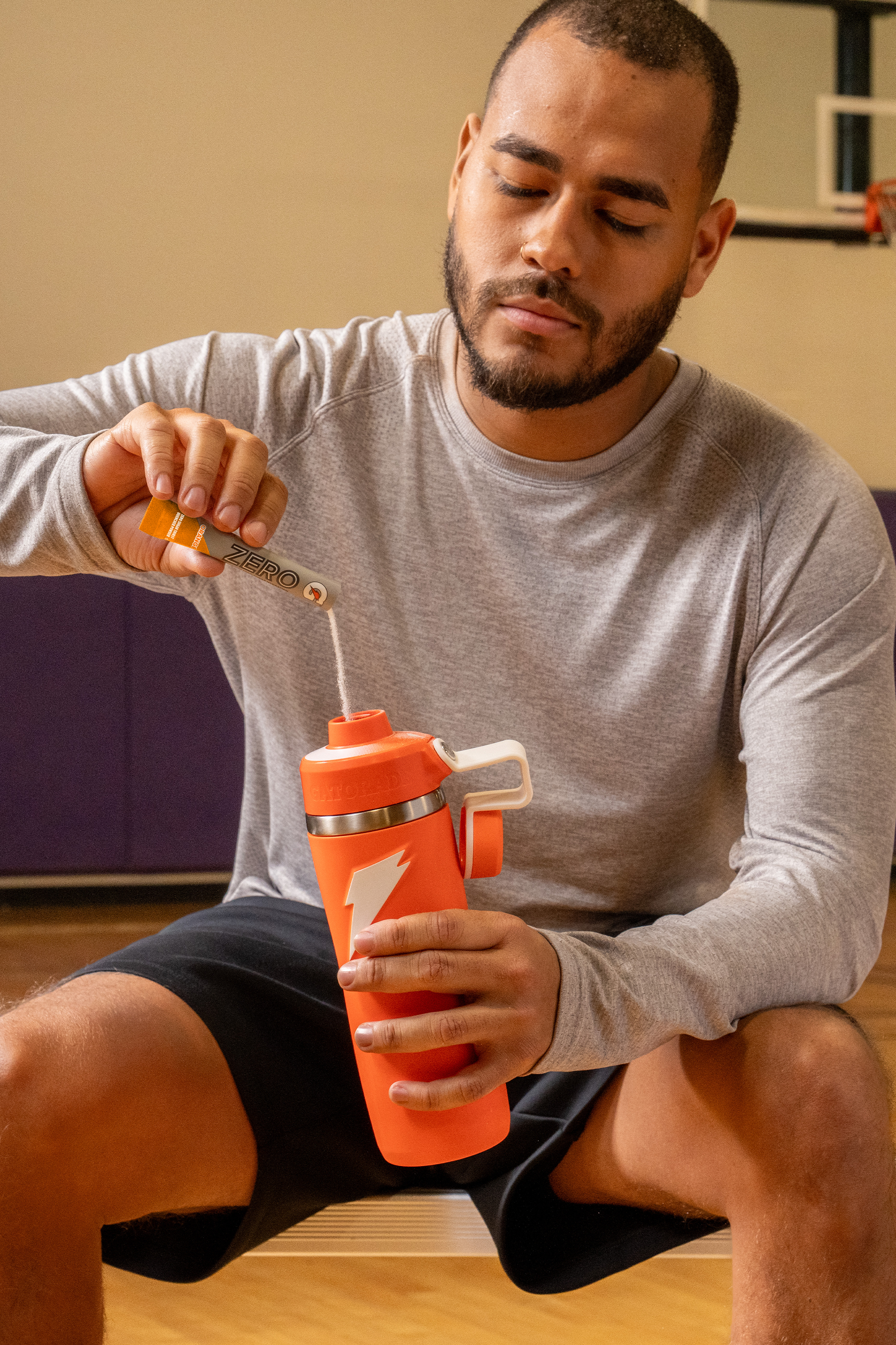 Gatorade Zero Single Serve Powder Orange being poured into overtime bottle