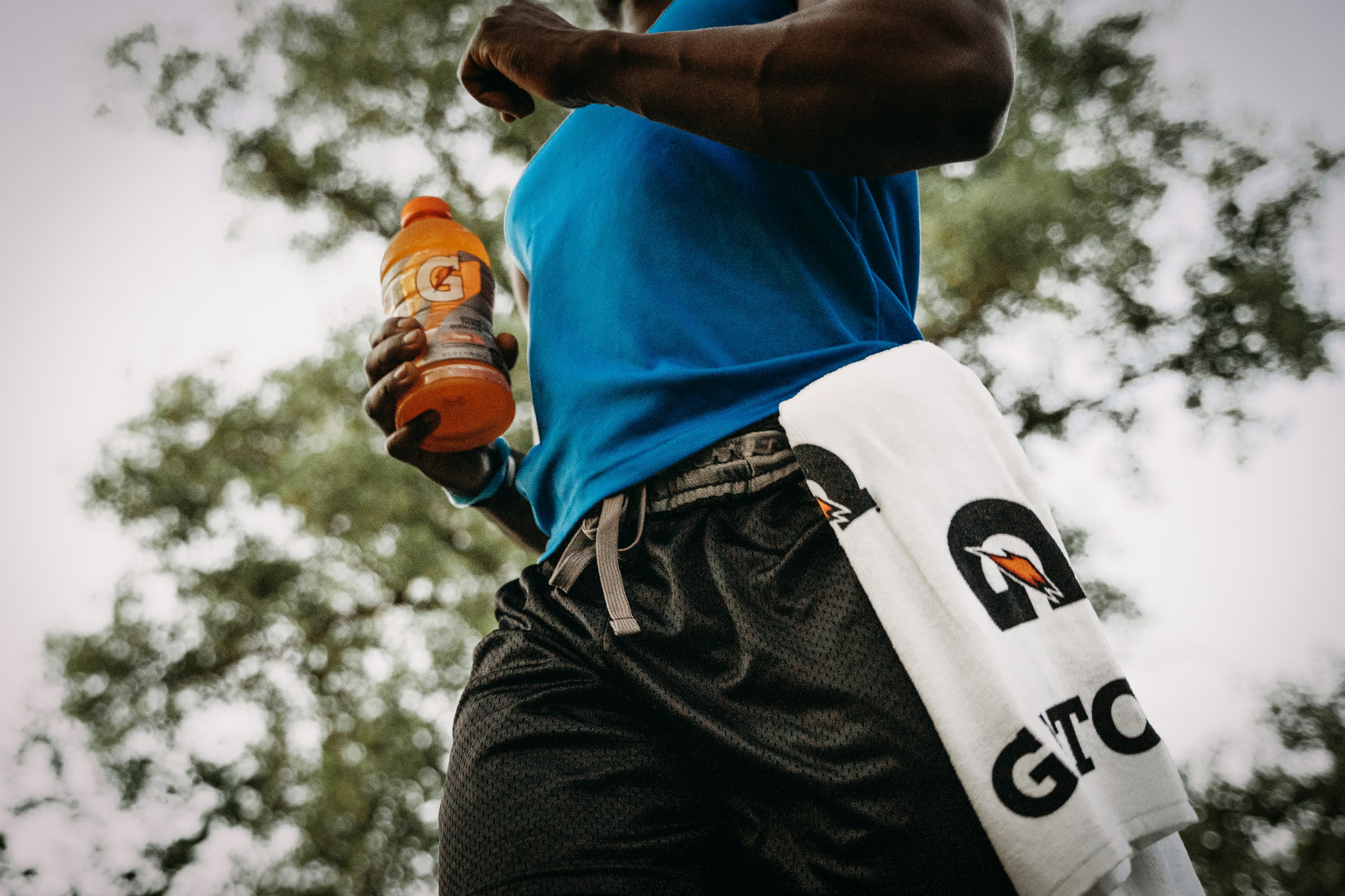 man running with gatorade bottle