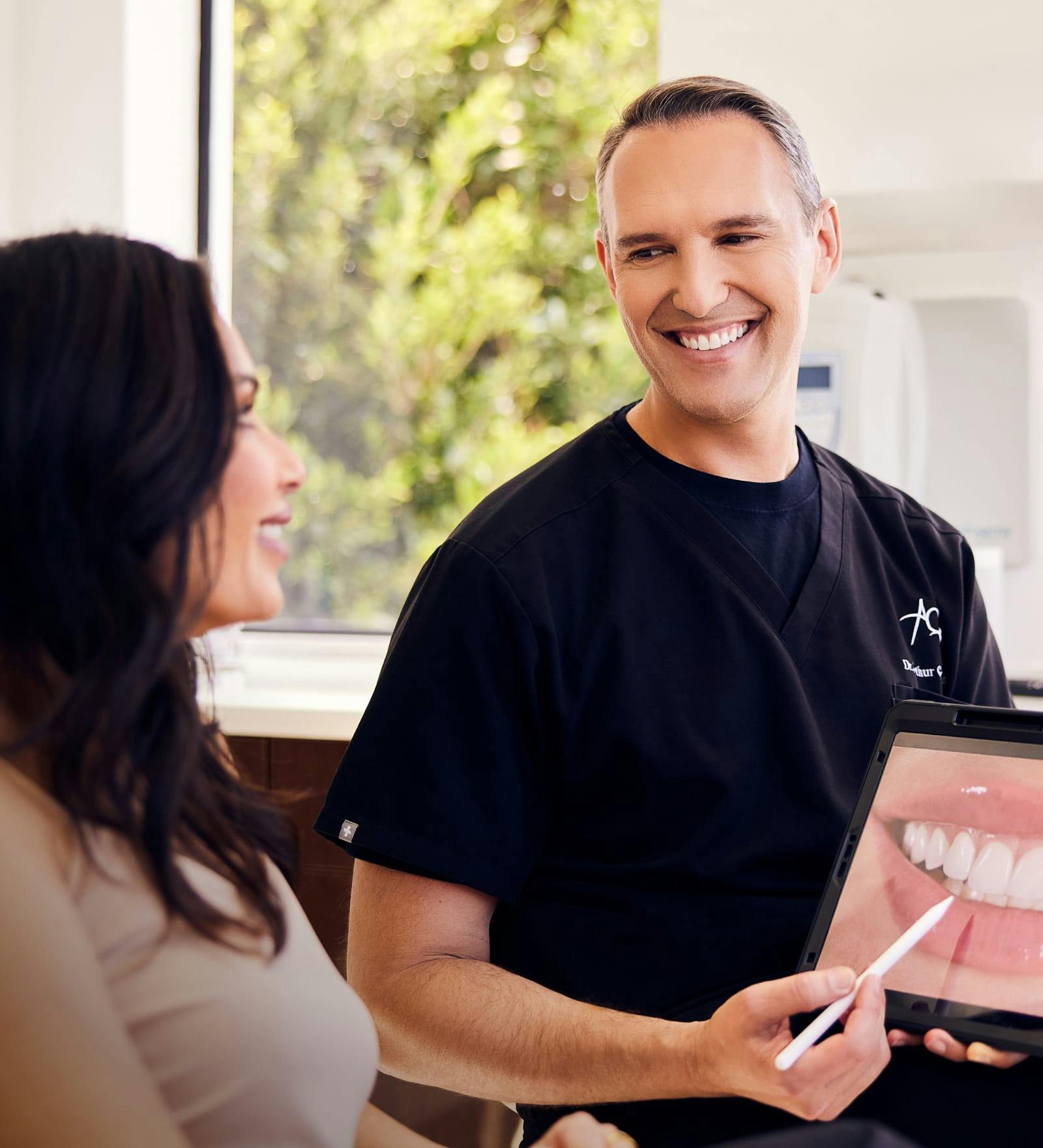 Dr. Arthur Glosman speaking with a femal patient