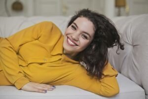 woman smiling after replacing broken veneer