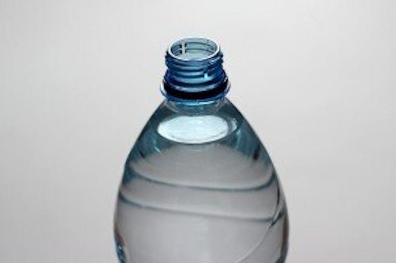 there is a bottle of water sitting on a table