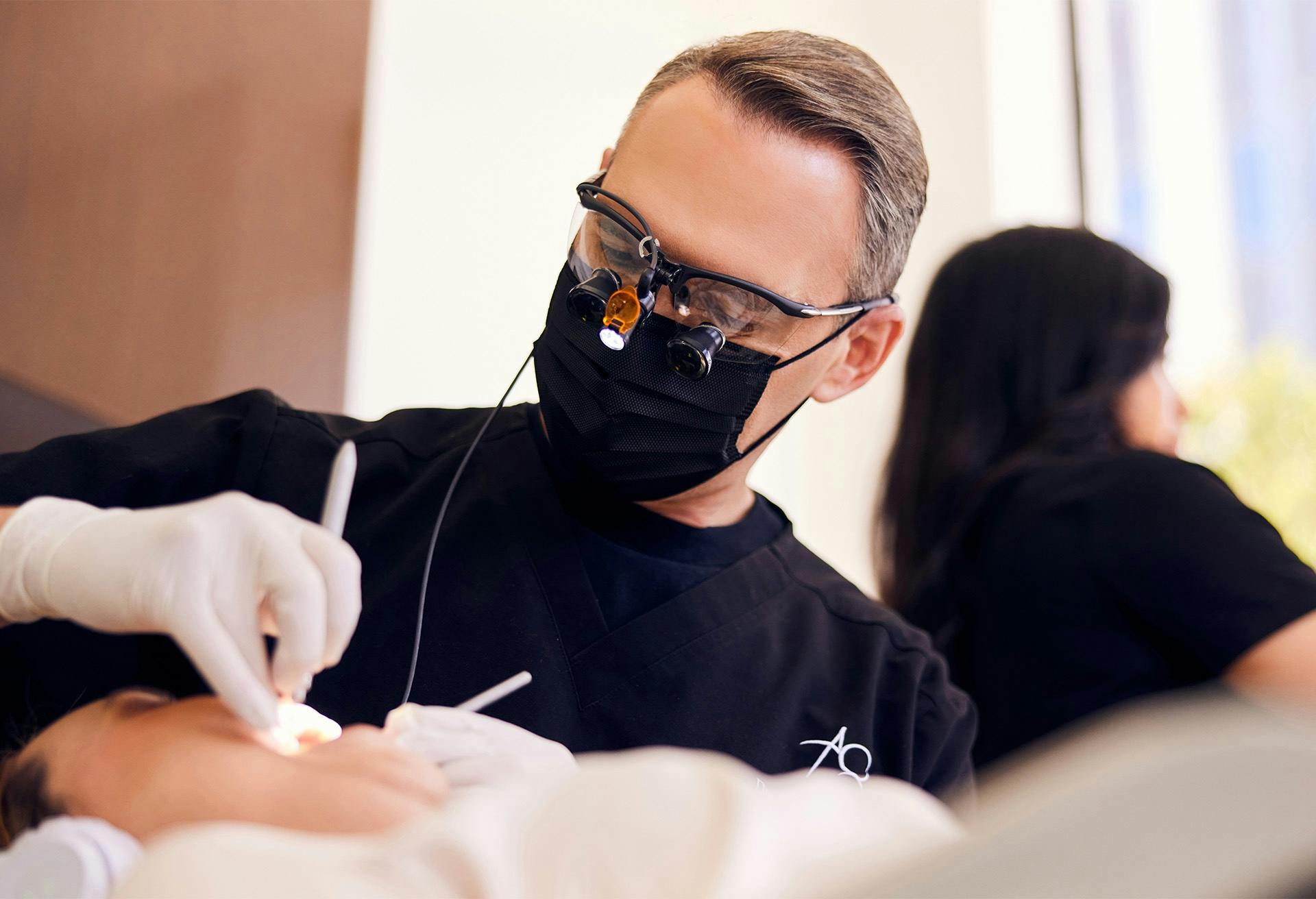 Dr. Glosman performing a dental procedure on a patient