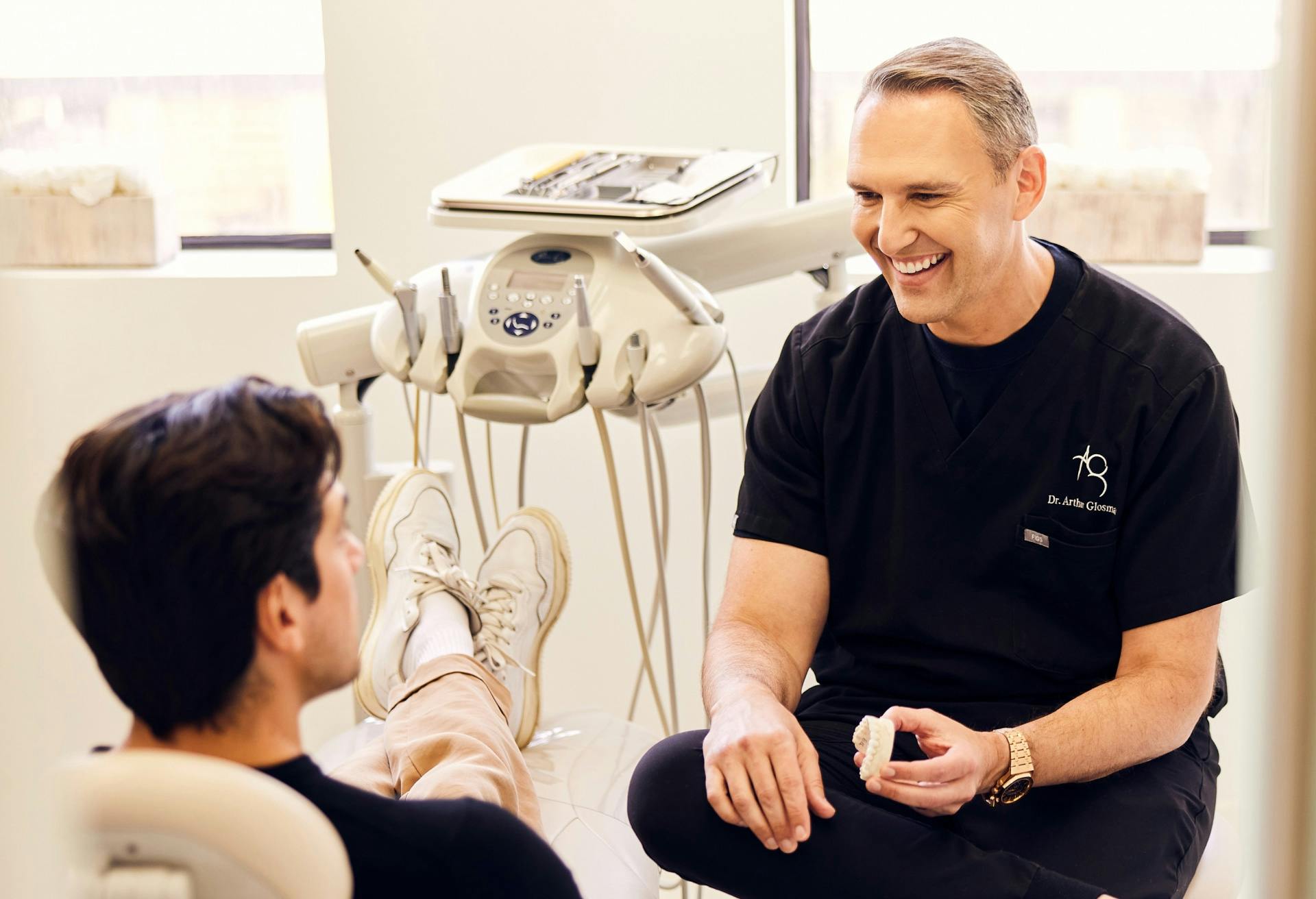 Dr. Glosman, a cosmetic dentist in Beverly Hills, speaking with a male patient