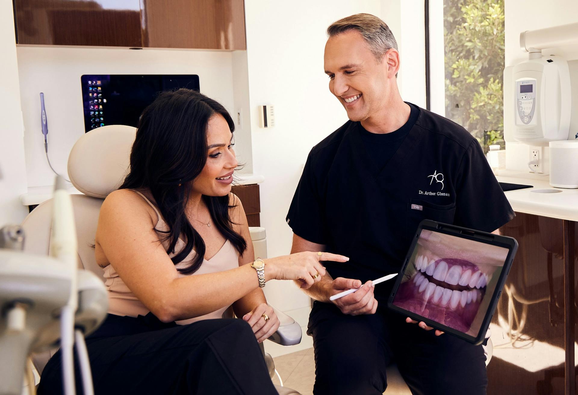 Dr. Glosman speaking with a patient about her full mouth reconstruciton