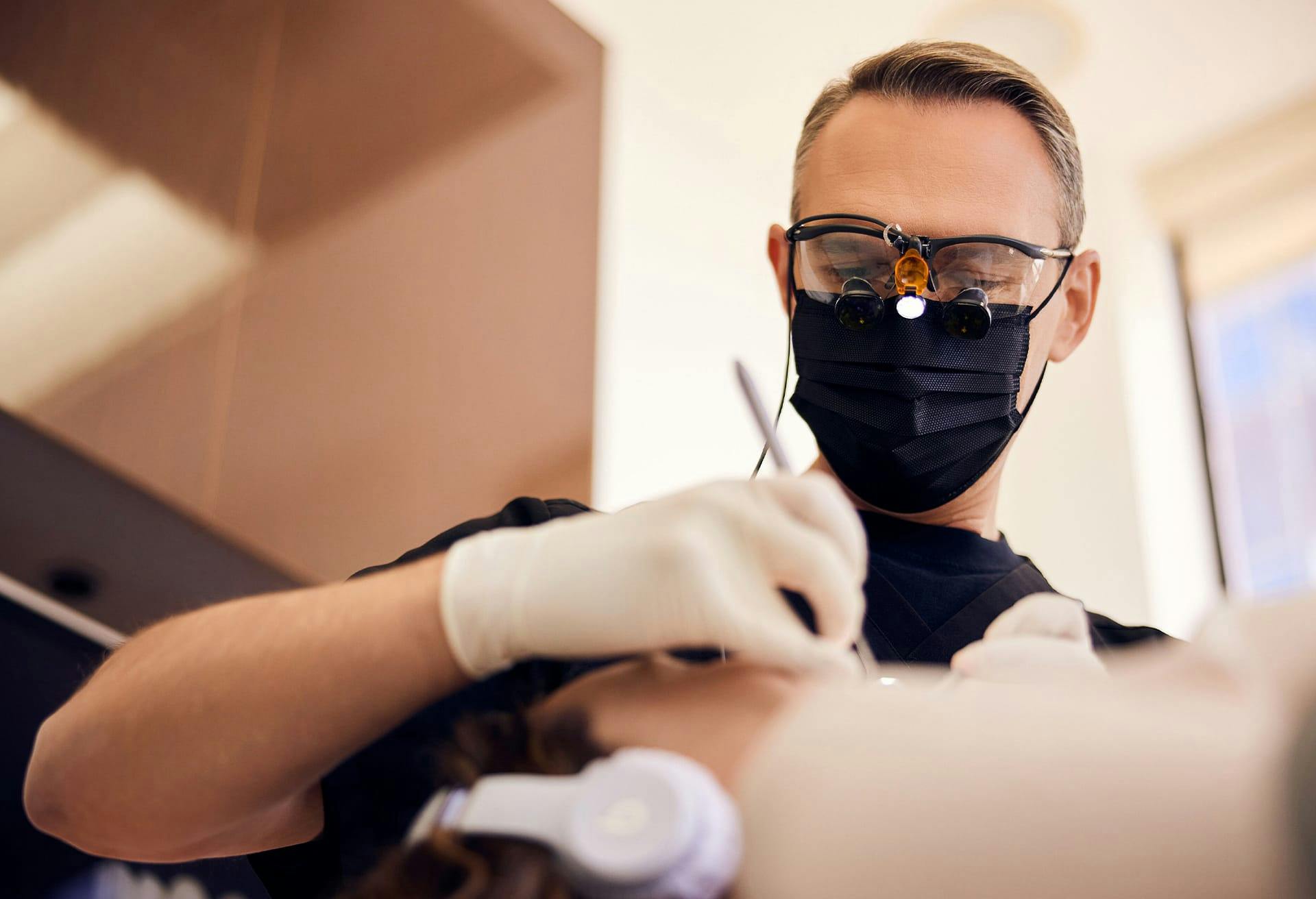 Dr. Glosman, dentist in Beverly Hills, performing dental work on a patient