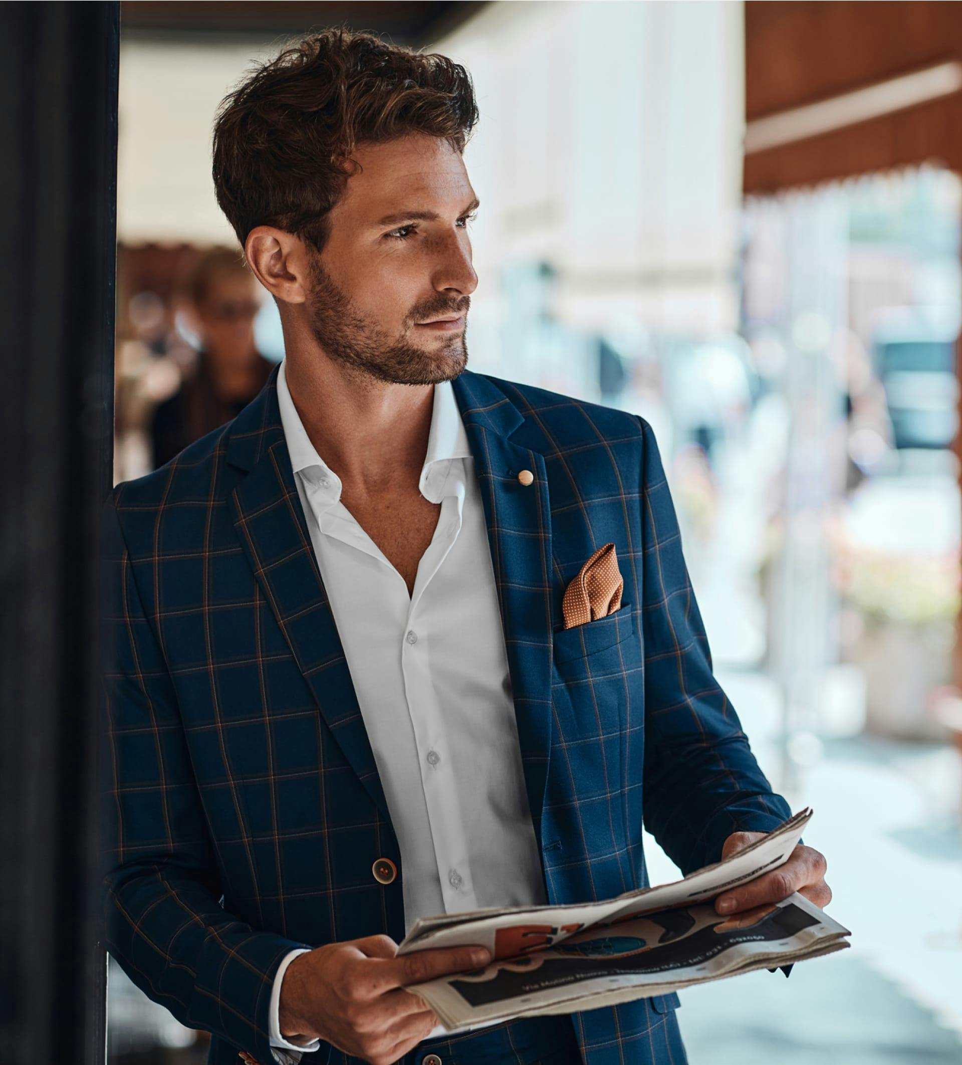 Man in suit holding news paper
