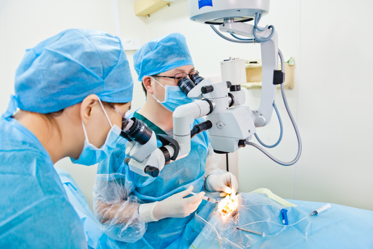 Doctors performing eye surgery