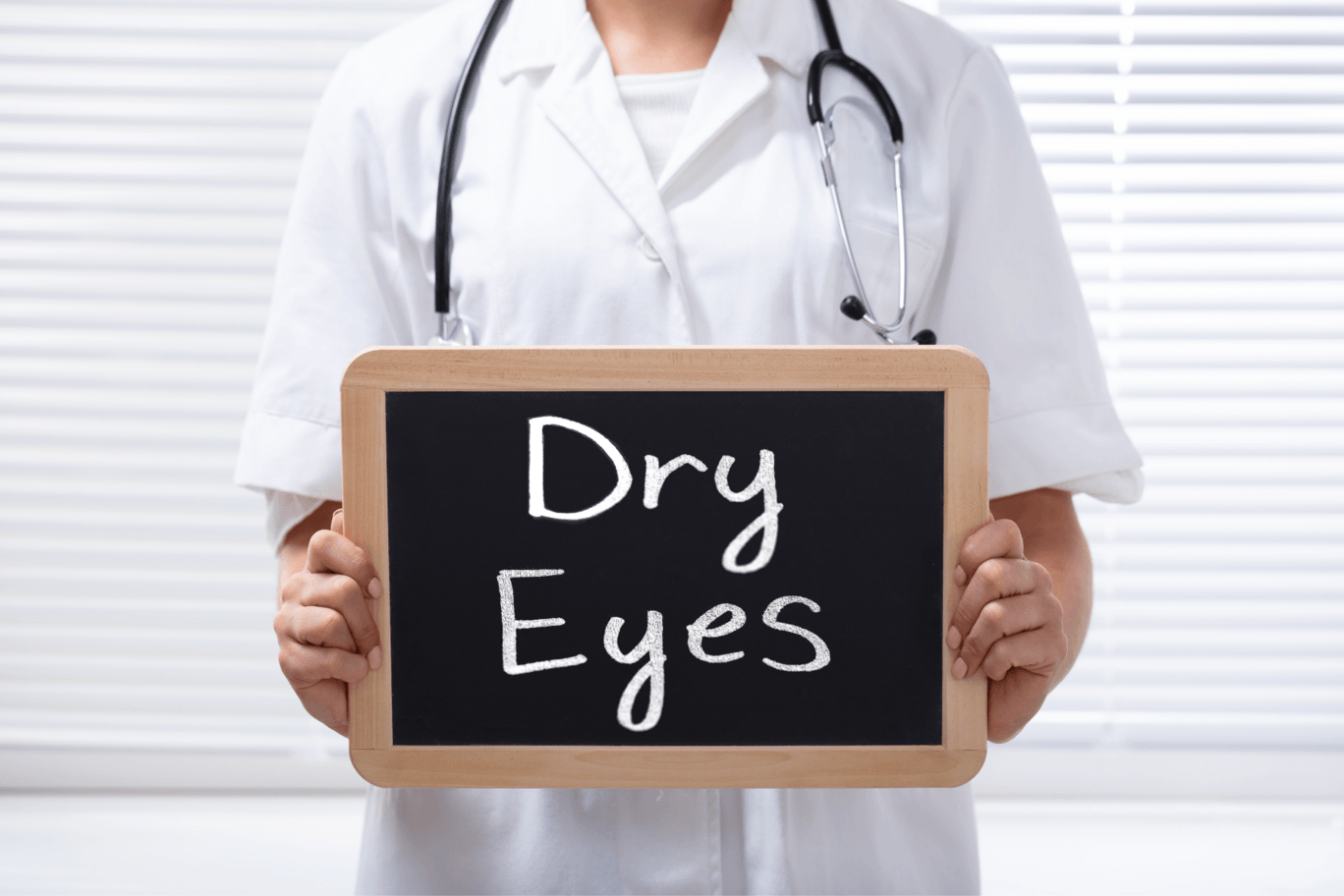 person holding sign that says dry eyes