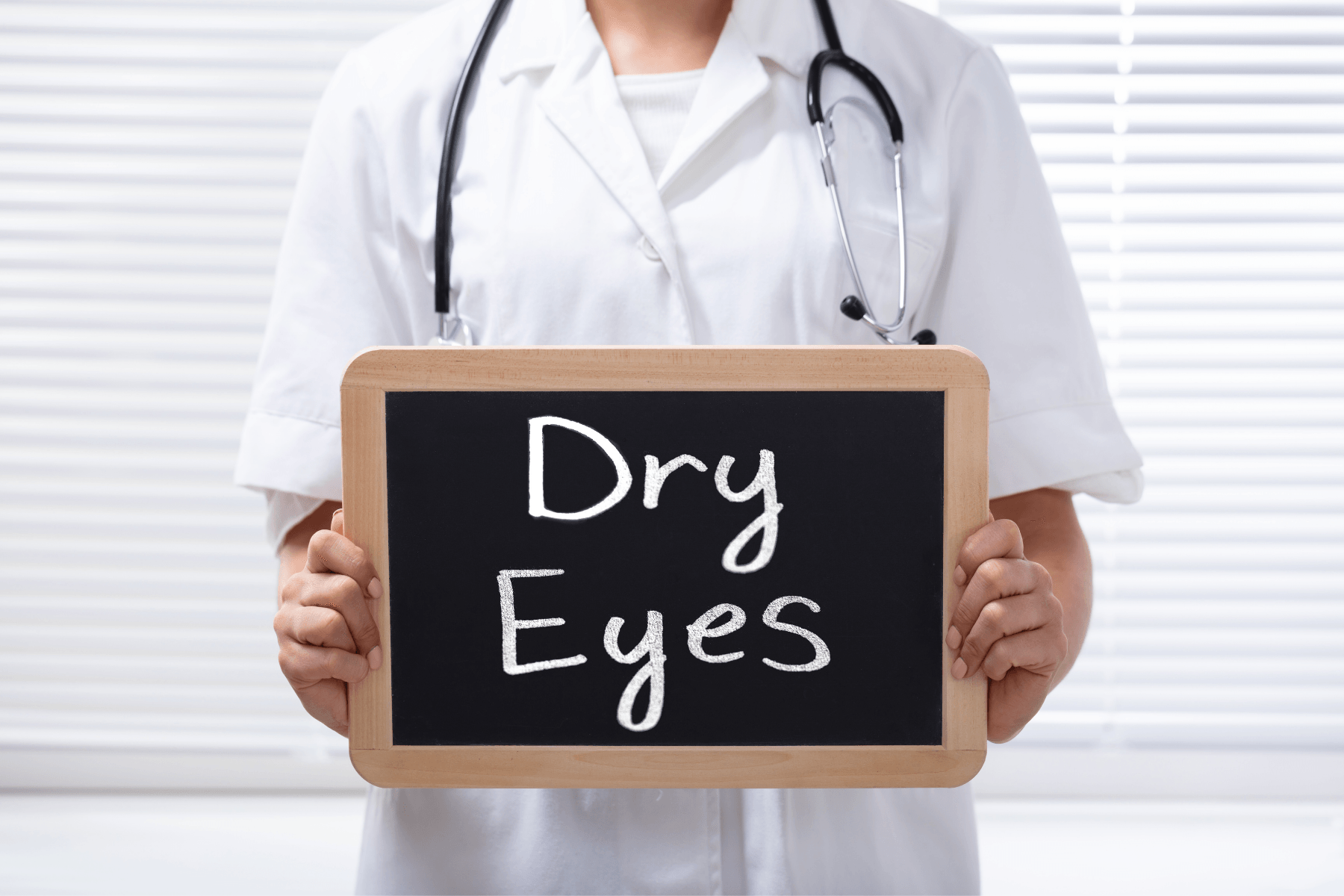 Woman holding sign that says dry eyes