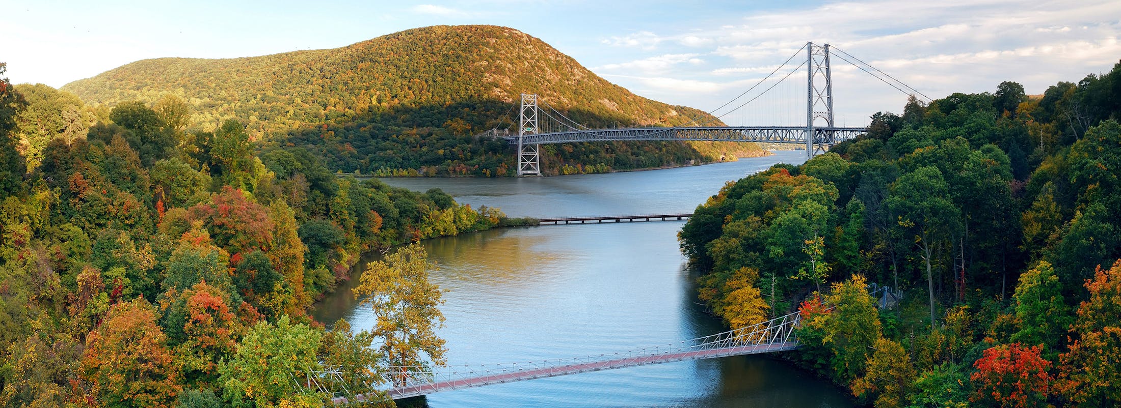 bridge over a river with a bridge in the background