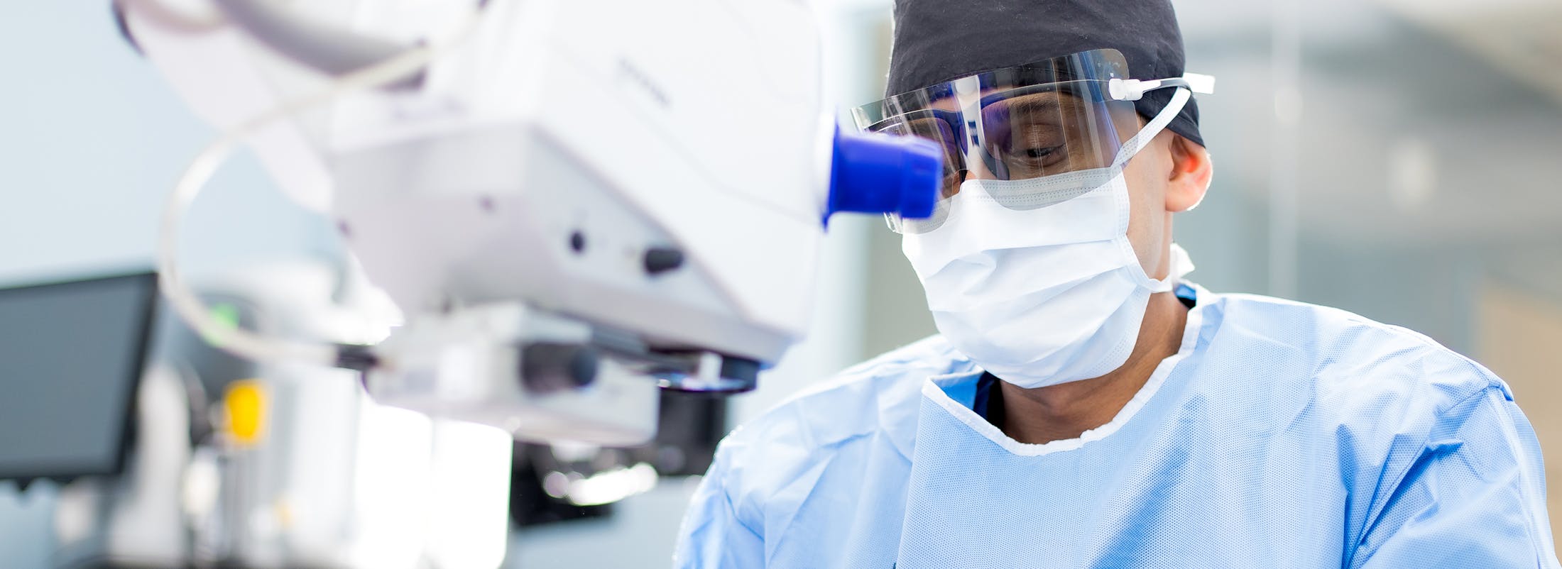 surgeon wearing a mask and goggles in a hospital