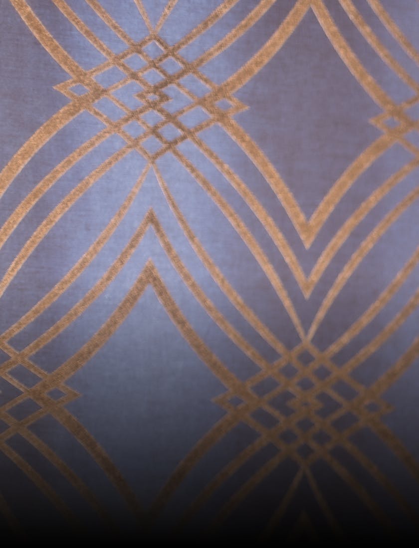 a close up of a wall with a gold pattern on it