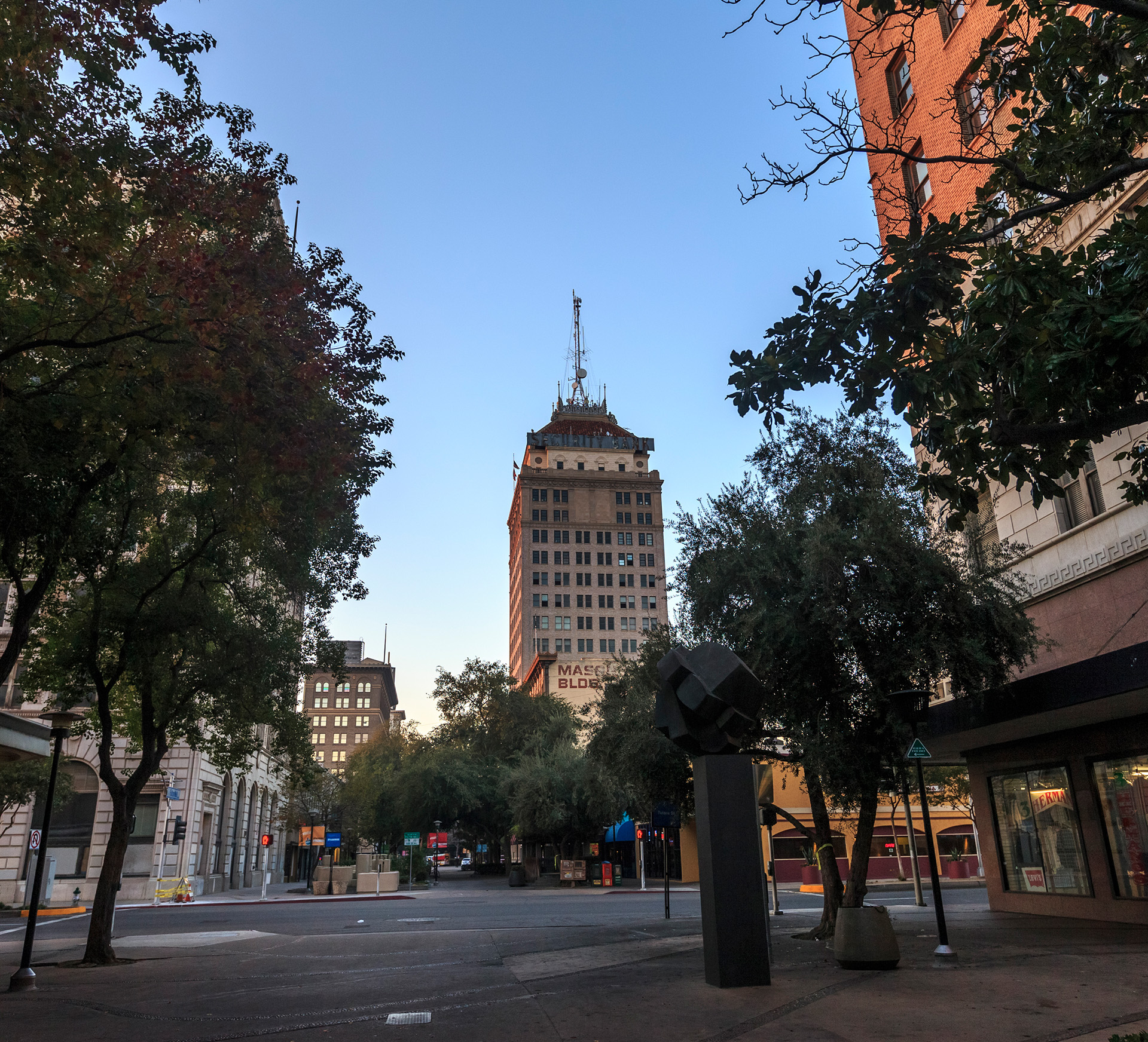 a picture at dusk of city intersection