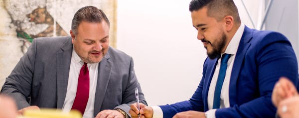 Two Lawyers Review Documents for Broken Chair Case