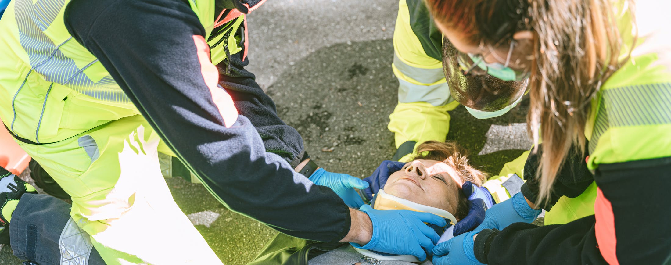 Woman Being Put in Neck Brace - Work Accident Banner