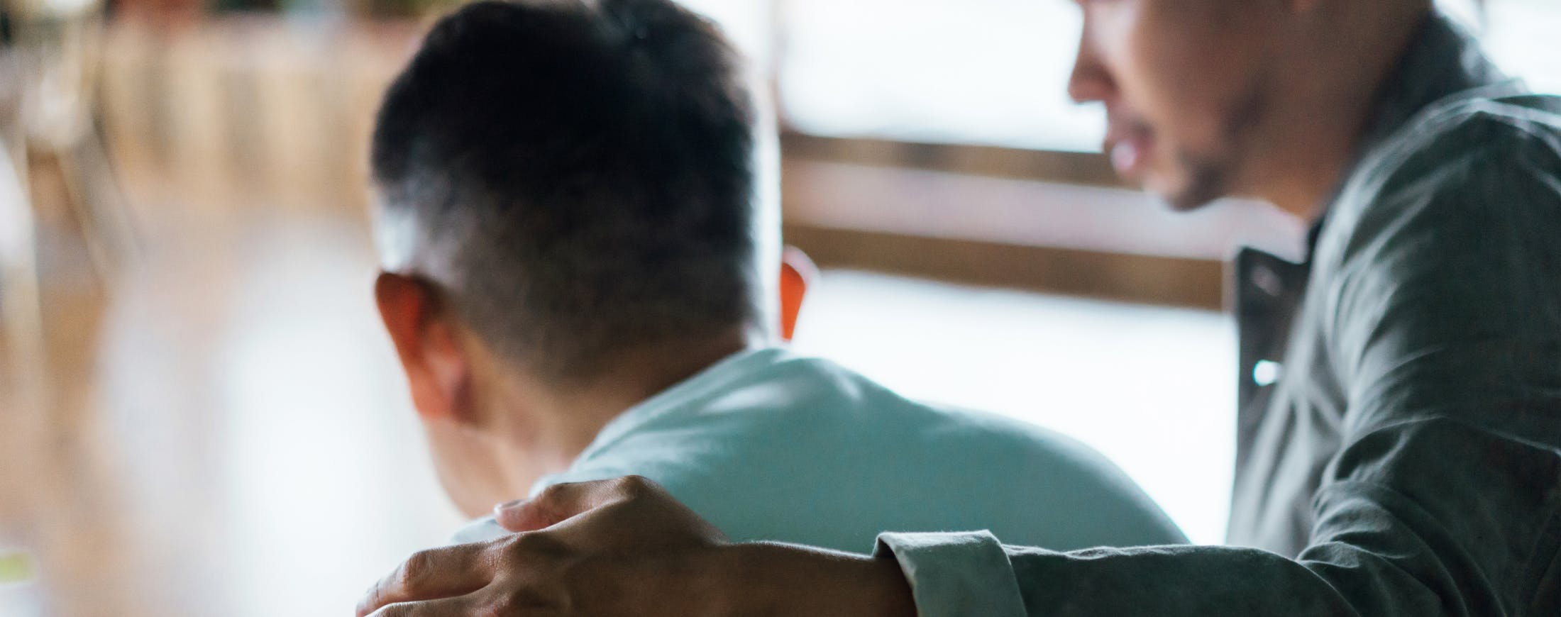 Man Comforting Another Man - Wrongful Death Banner