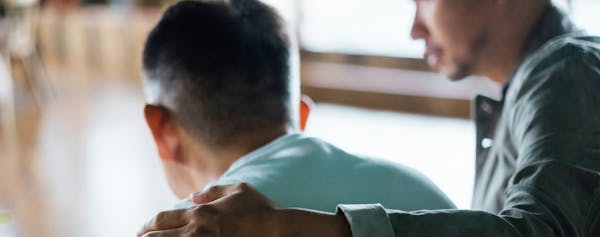 Man Comforting Another Man - Wrongful Death Banner