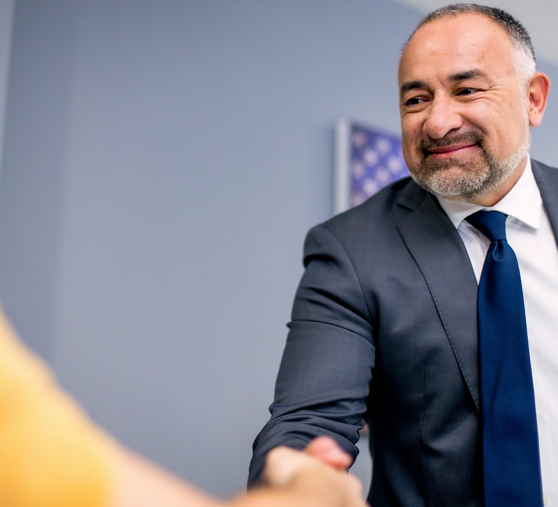 Gilbert Perez III with Fiore Legal Injury Attorneys shaking a client's hand