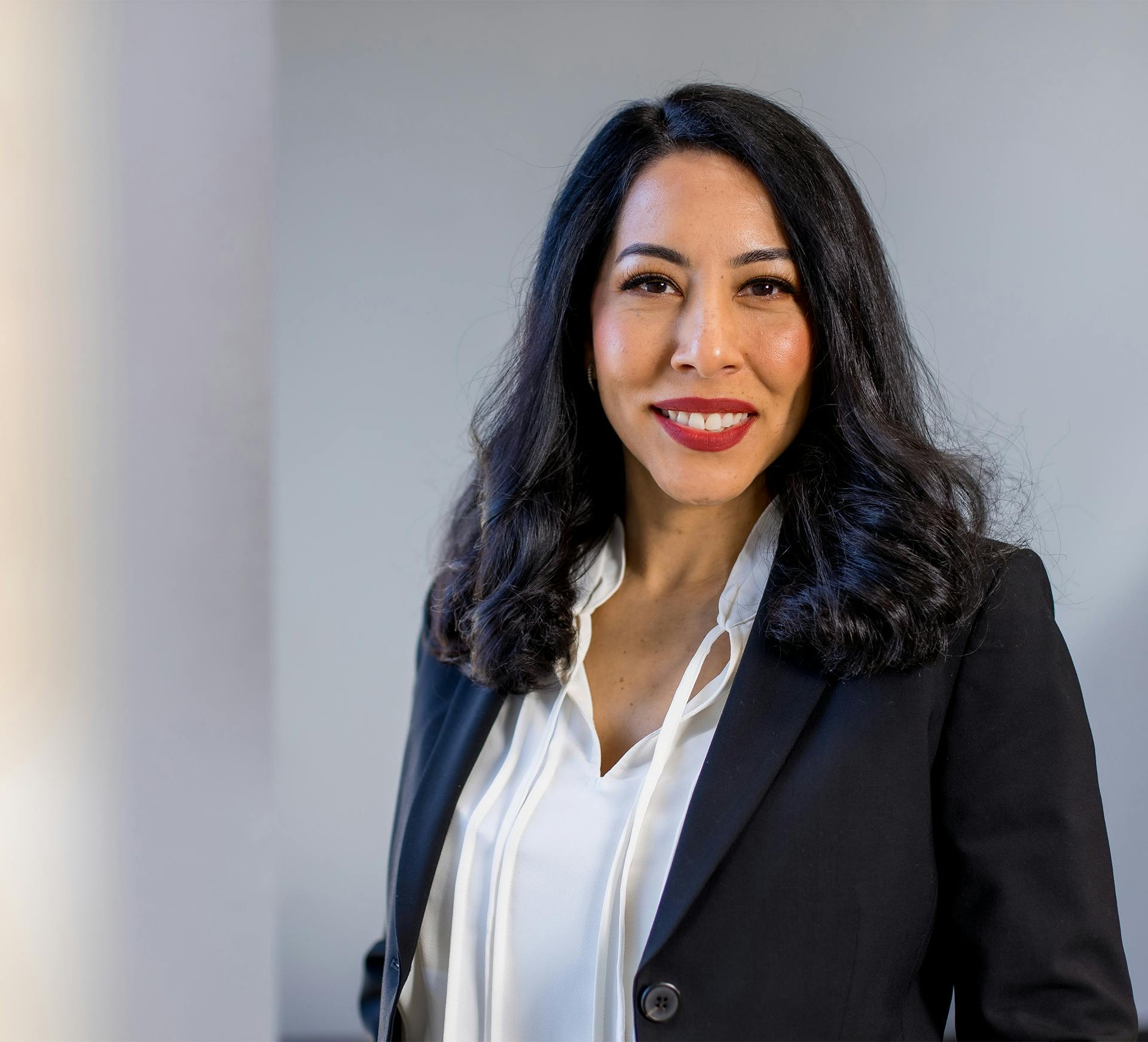 Krystale Rosal with Fiore Legal Injury Attorneys in black blazer and white blouse