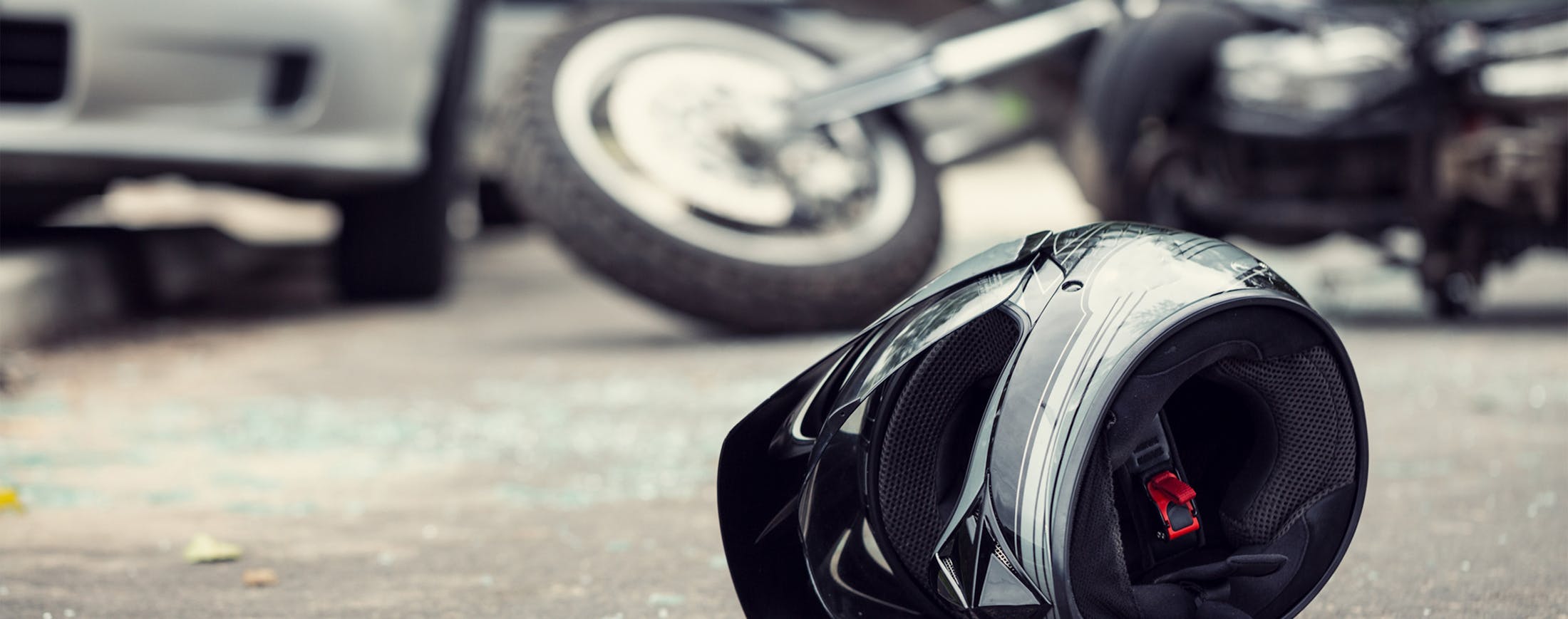 Image of Helmet with Bike Destroyed in Background - Banner