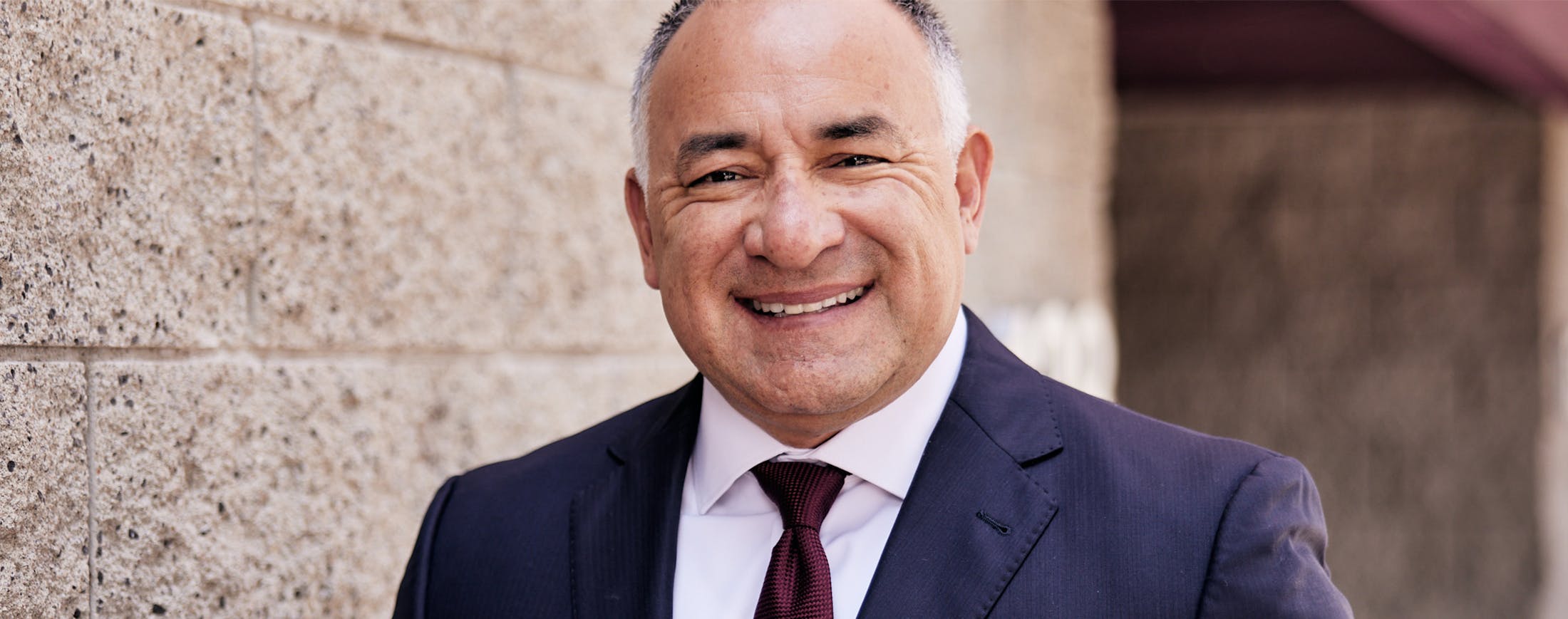 Middle-aged man smiling while wearing a suit