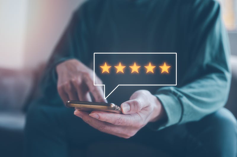 man using smartphone give review and five stars rating