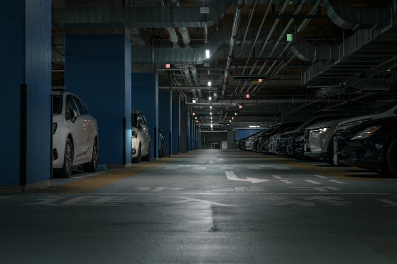 dimly lit parking garage with parked cars
