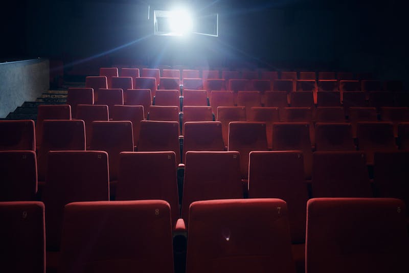 group of empty red seats in a movie theatre