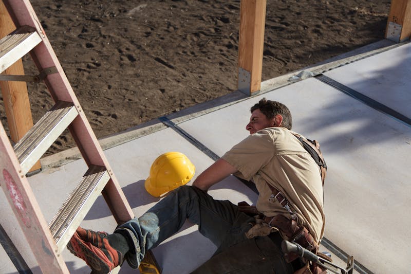 man who has fallen off a ladder during construction
