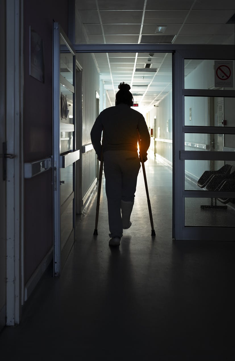 A woman walking with crutches