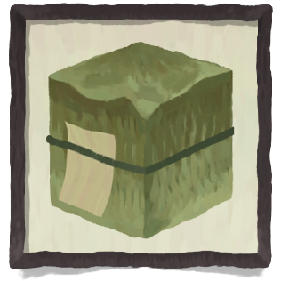 A green block with a green string tied around it with a paper note