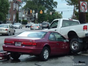 Red car and white truck in vehicle accident