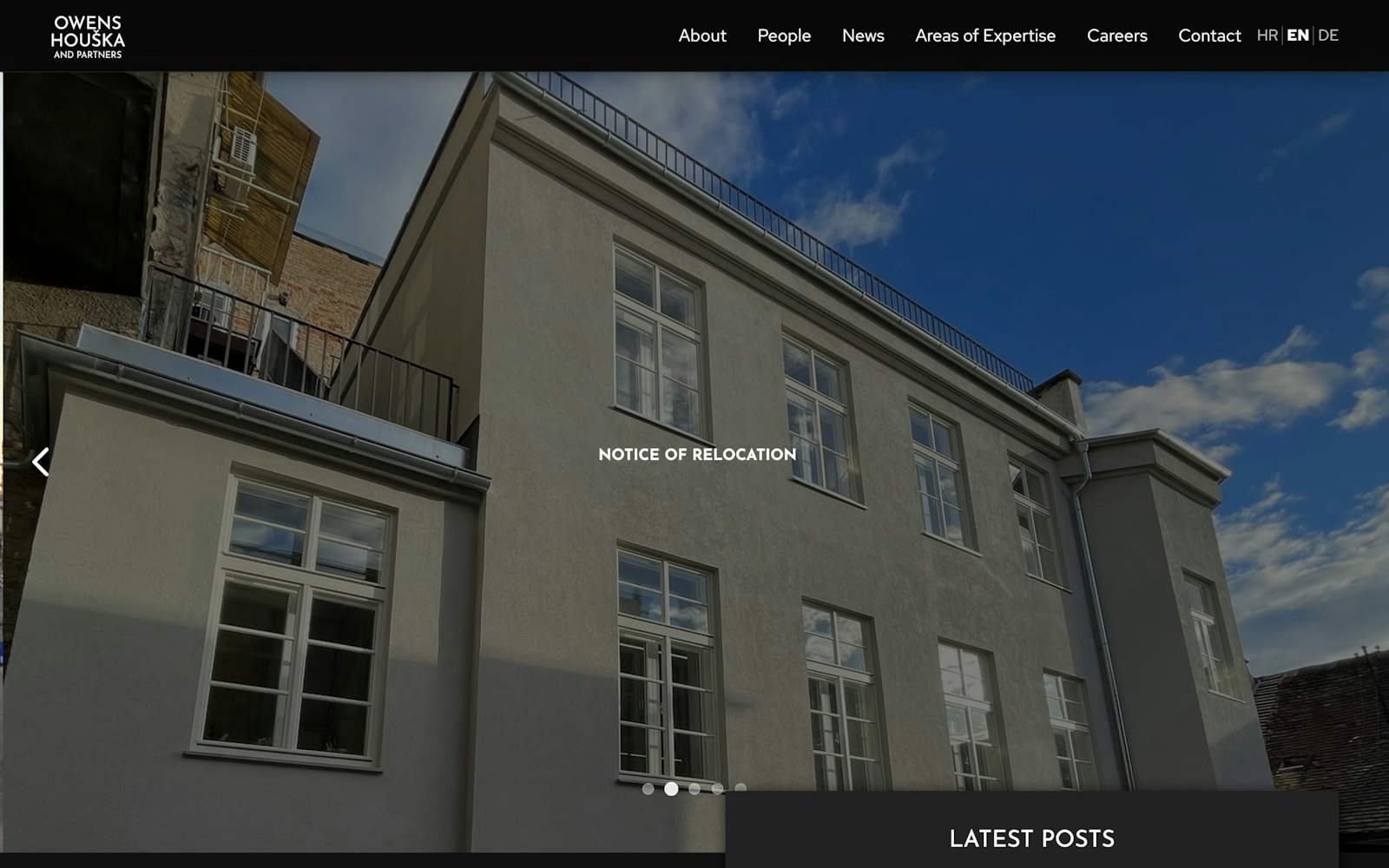 English home page with a photo slider of a building and a Latest posts panel.