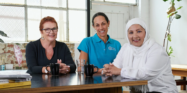 Two women with lived experience sit with an Ovarian Cancer Australia Support team member