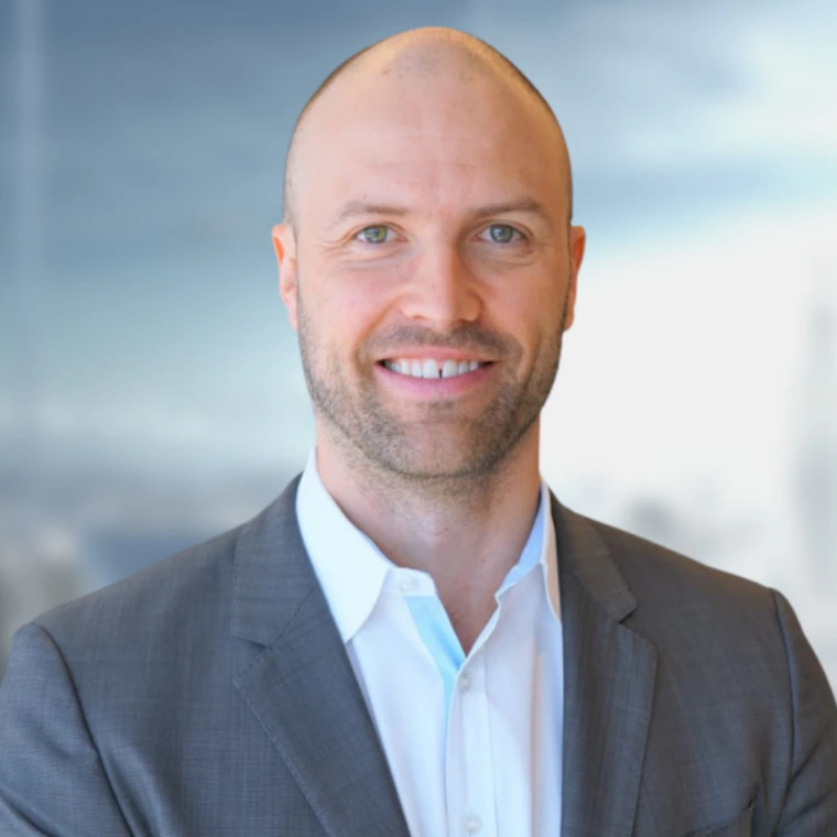 Bald man in grey suit and white shirt