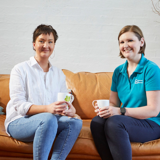 Woman with ovarian cancer and her teal support nurse having coffee