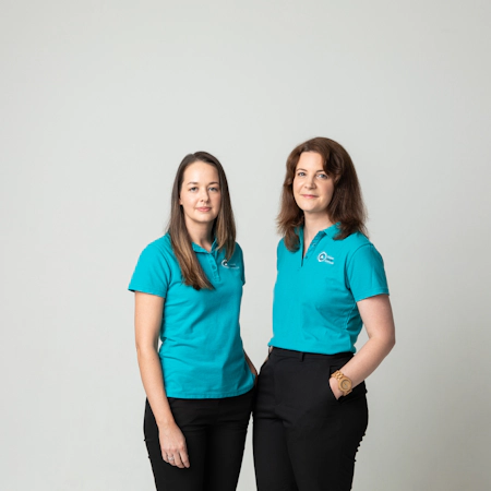 two support team members from ovarian cancer australia in teal shirts