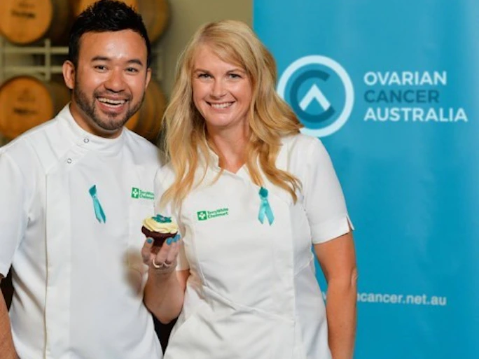two chemists from Terrywhite Chemmart wearing teal ribbons in support for ovarian cancer australia.