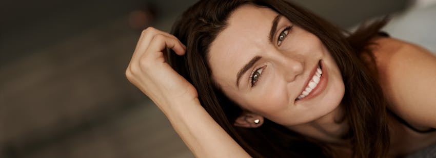 brunette woman leaning on hand