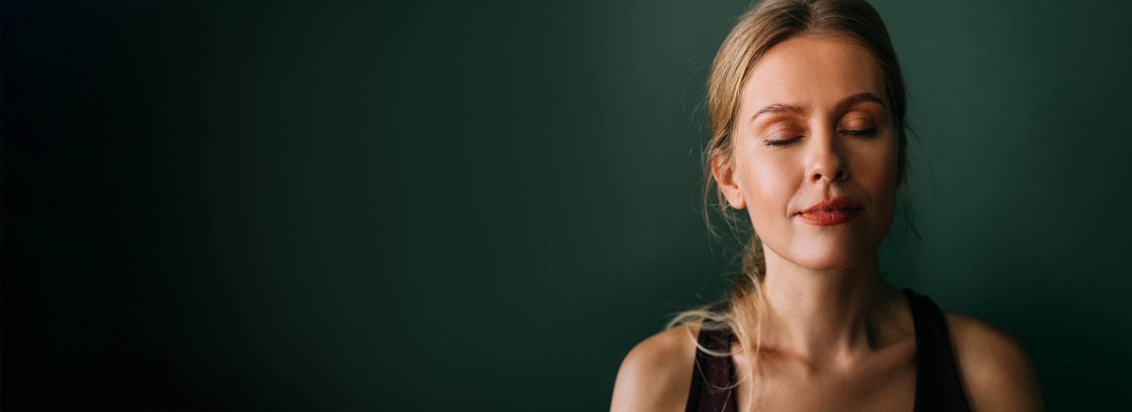 blonde woman with eyes closed