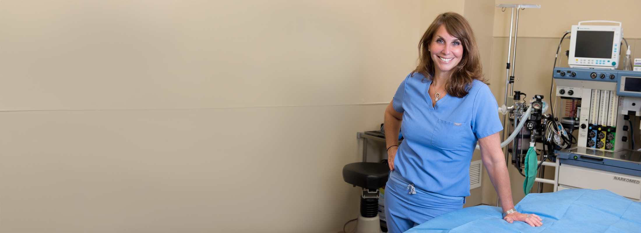 Dr. Shermak smiling in scrubs