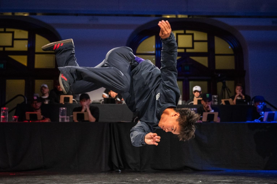 Jeff Dunne mid-flip in a breakdancing competition.