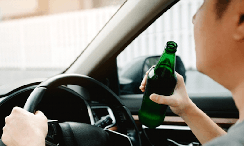 Man drinking at the wheel
