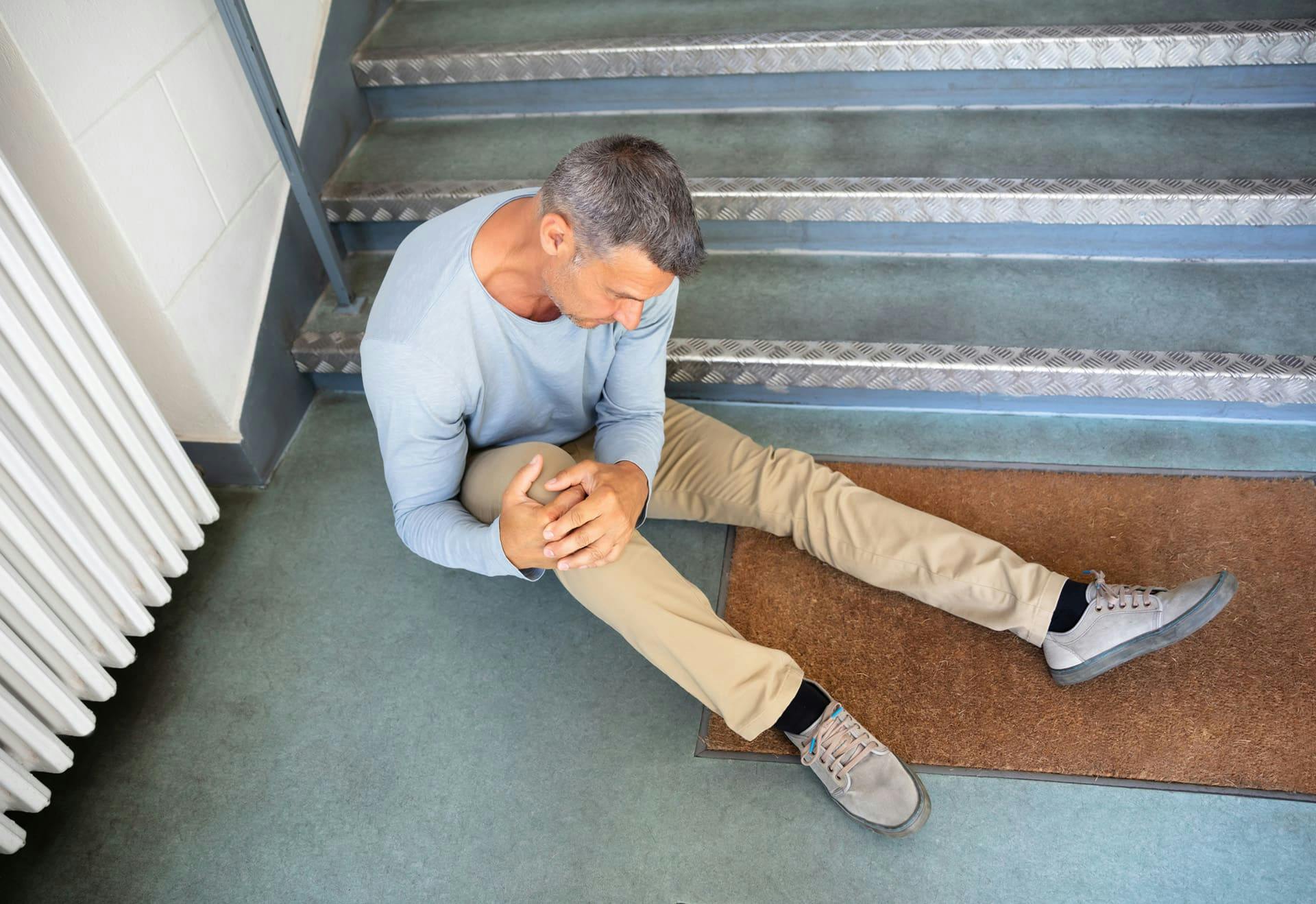 Man on the ground holding his knee