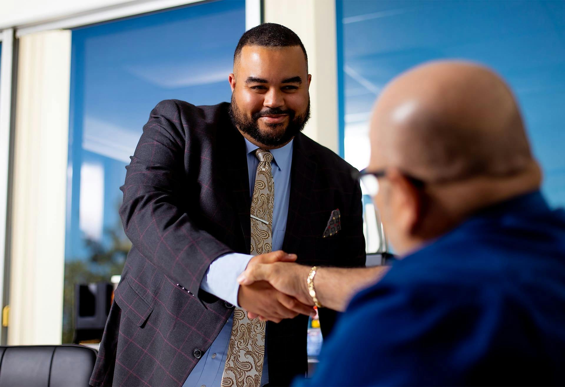 Vincent Hughes shaking hands with a client.