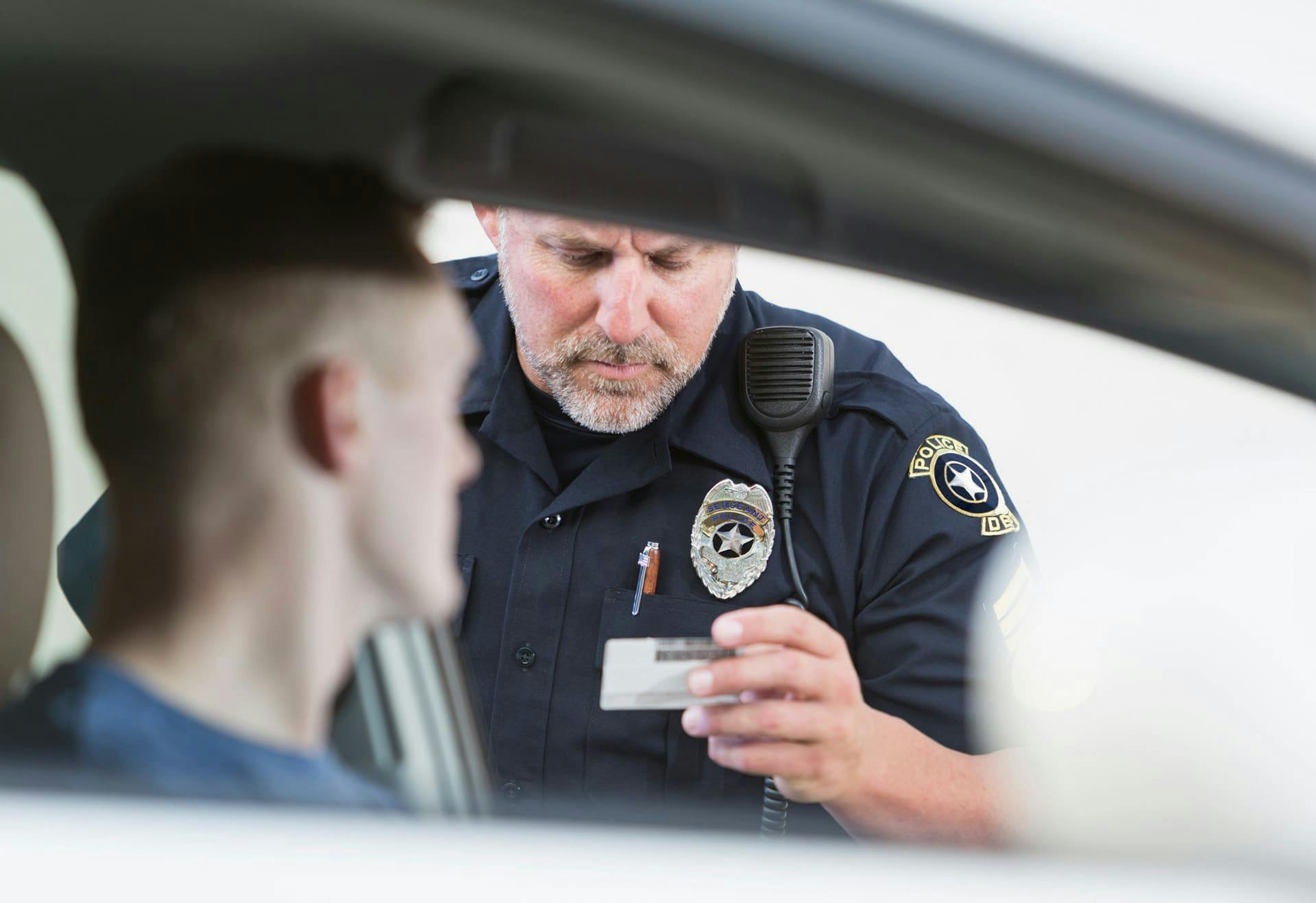 Officer looking at a man's license.