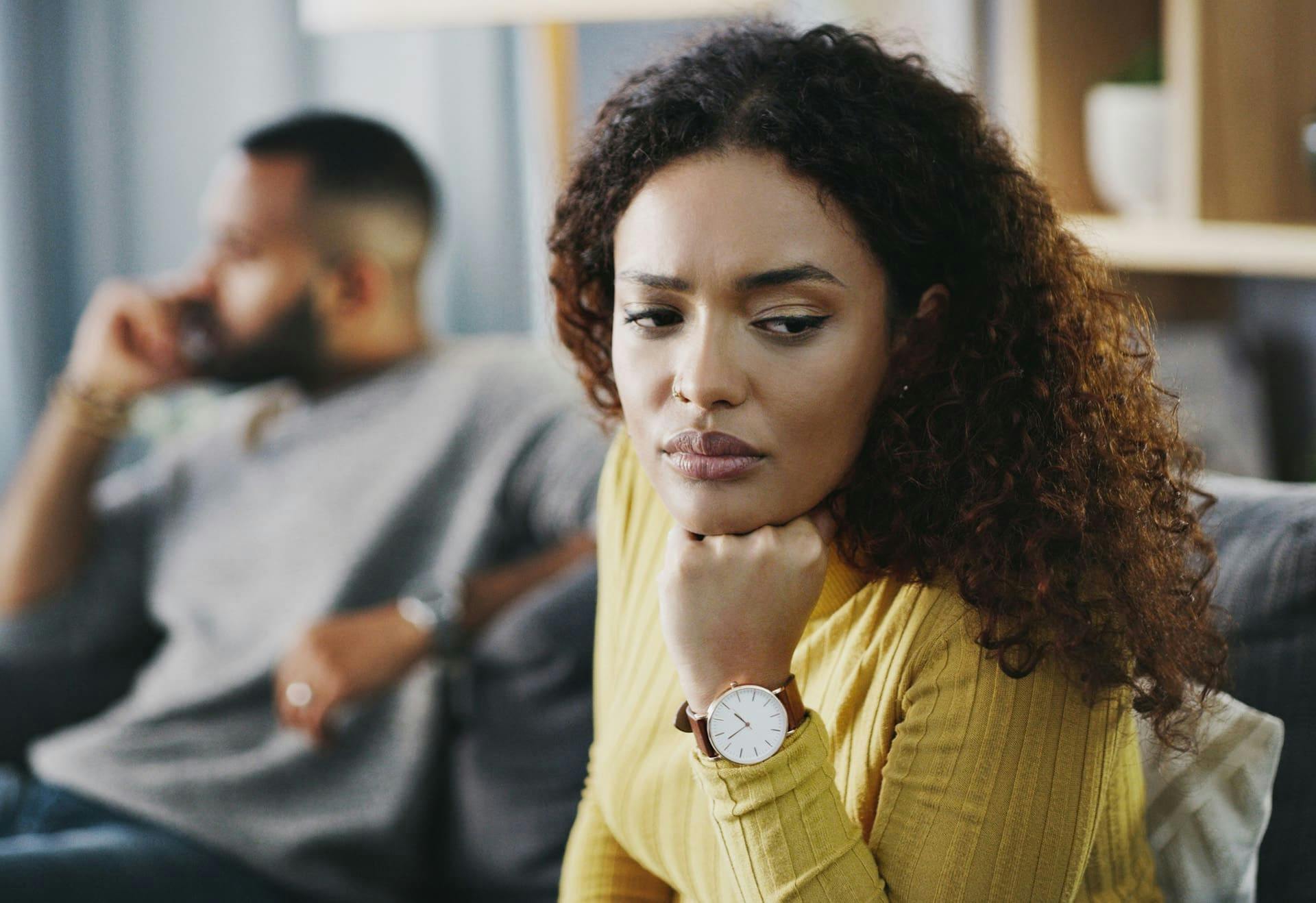 Woman looking away from her husband in distress.