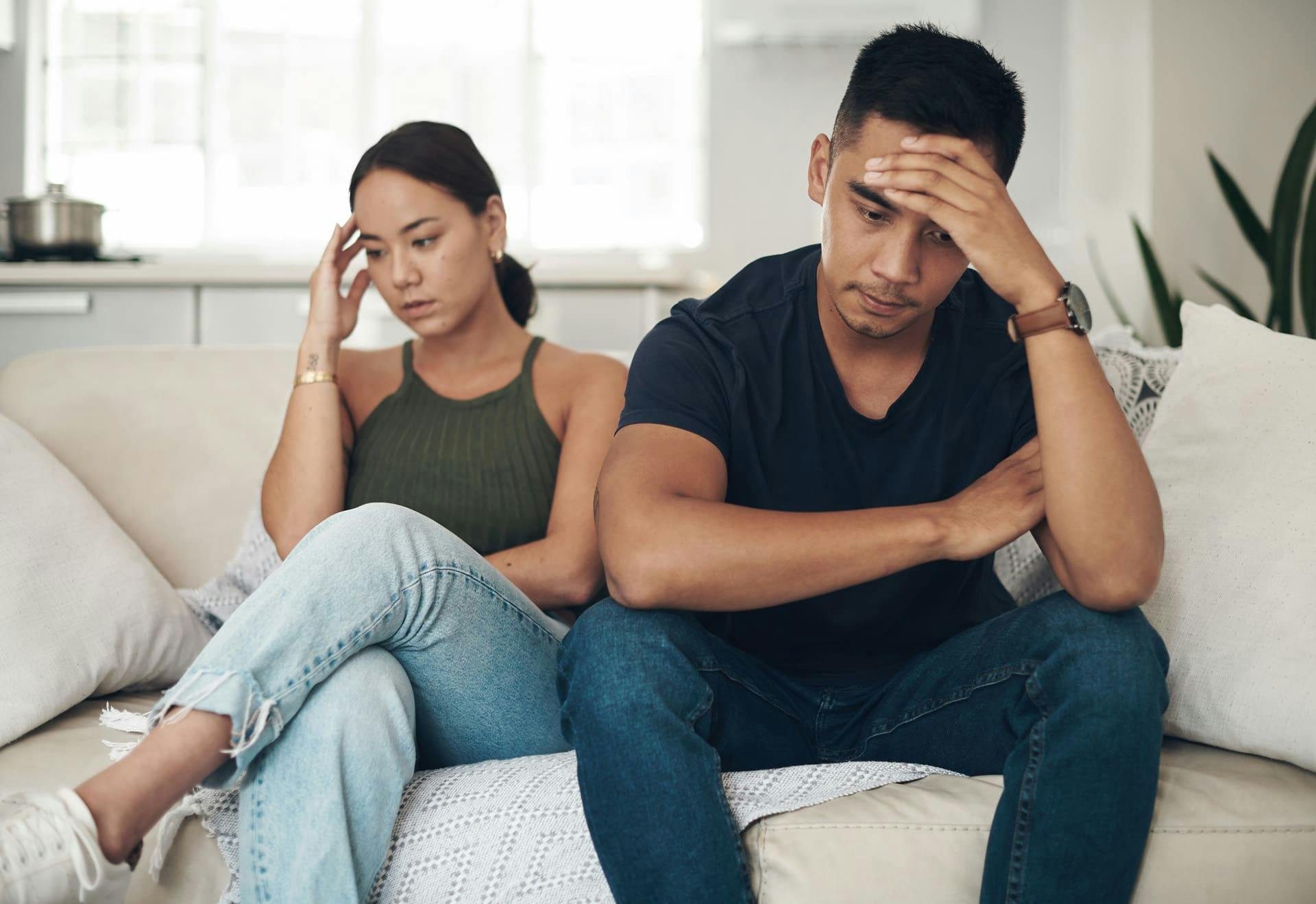 Two upset people on a couch