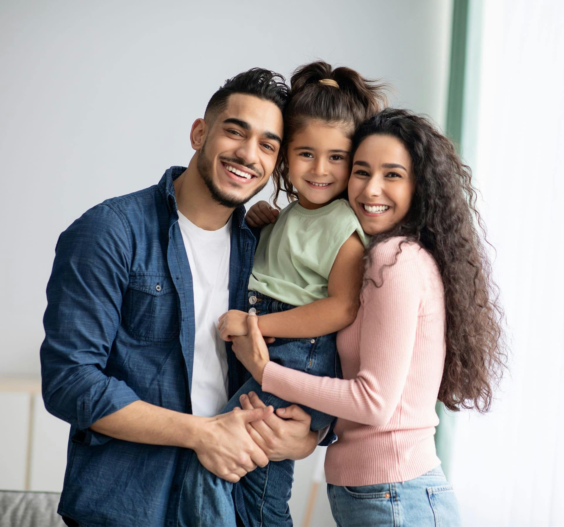 Happy man and woman with a child.