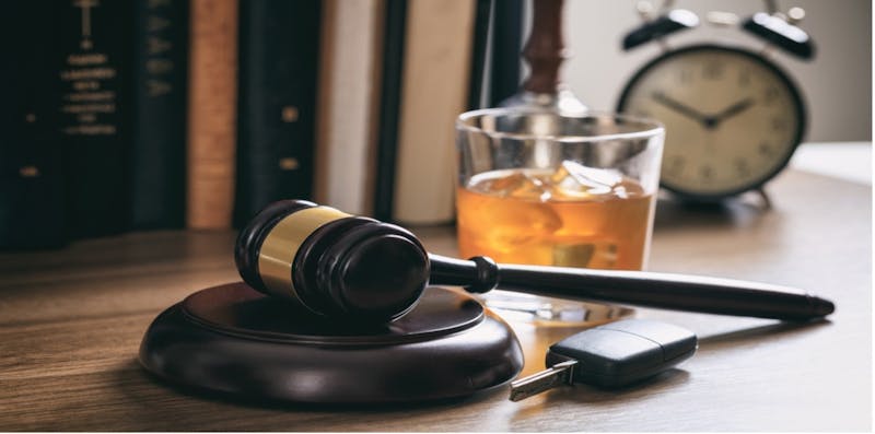 Alcohol glass, keys, and a gavel and block